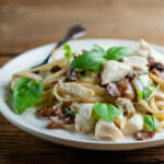 Bacon crab pasta on a plate with a fork.