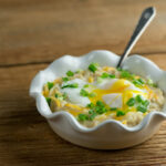 Savory Oatmeal in a bowl with a spoon.