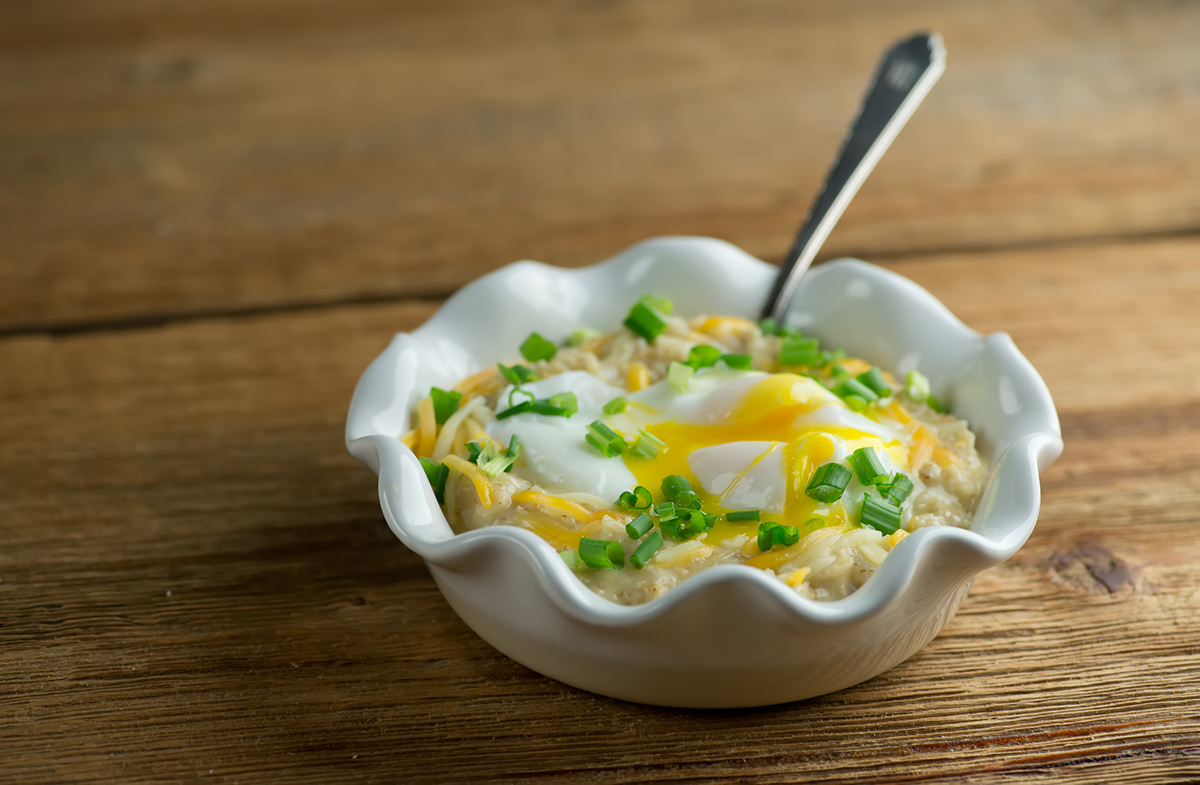 Savory Oatmeal in a bowl with a spoon.