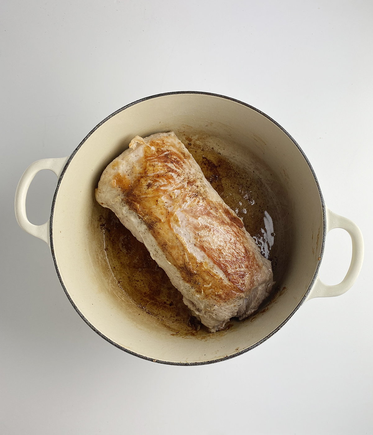 Seared pork roast in a pot.