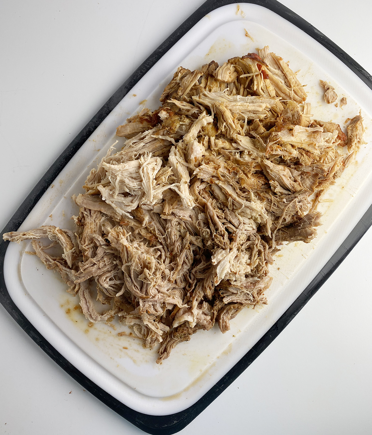 Shredded pork on a cutting board.