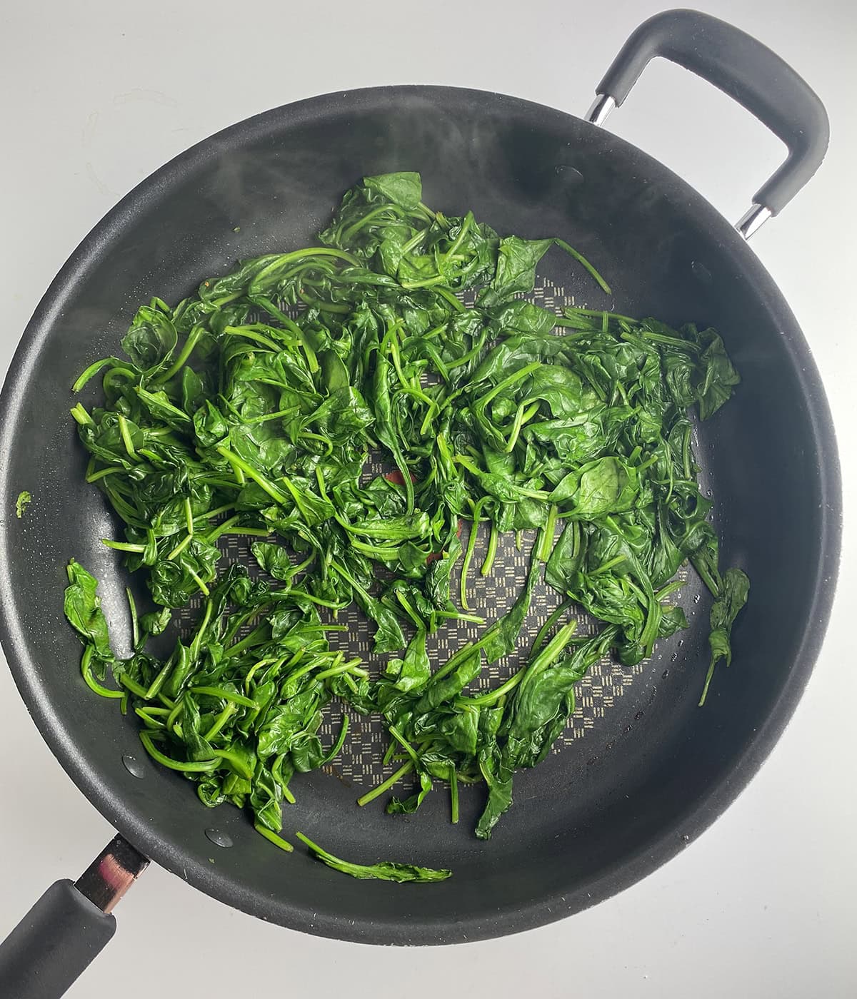 Spinach cooking in a pan.