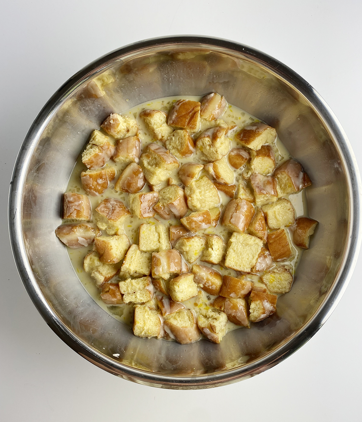 Cinnamon roll bread pudding mixture in a bowl.