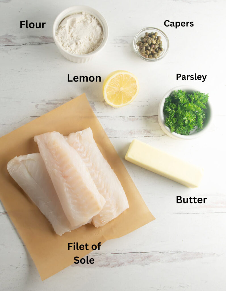 Ingredients for Julia Child's filet of sole on a wooden counter.