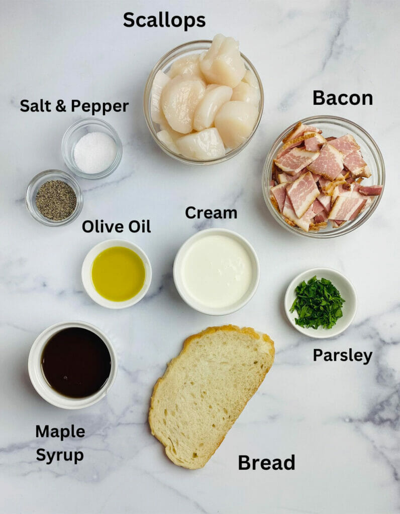 Ingredients for scallops in maple bacon cream sauce on a marble counter.