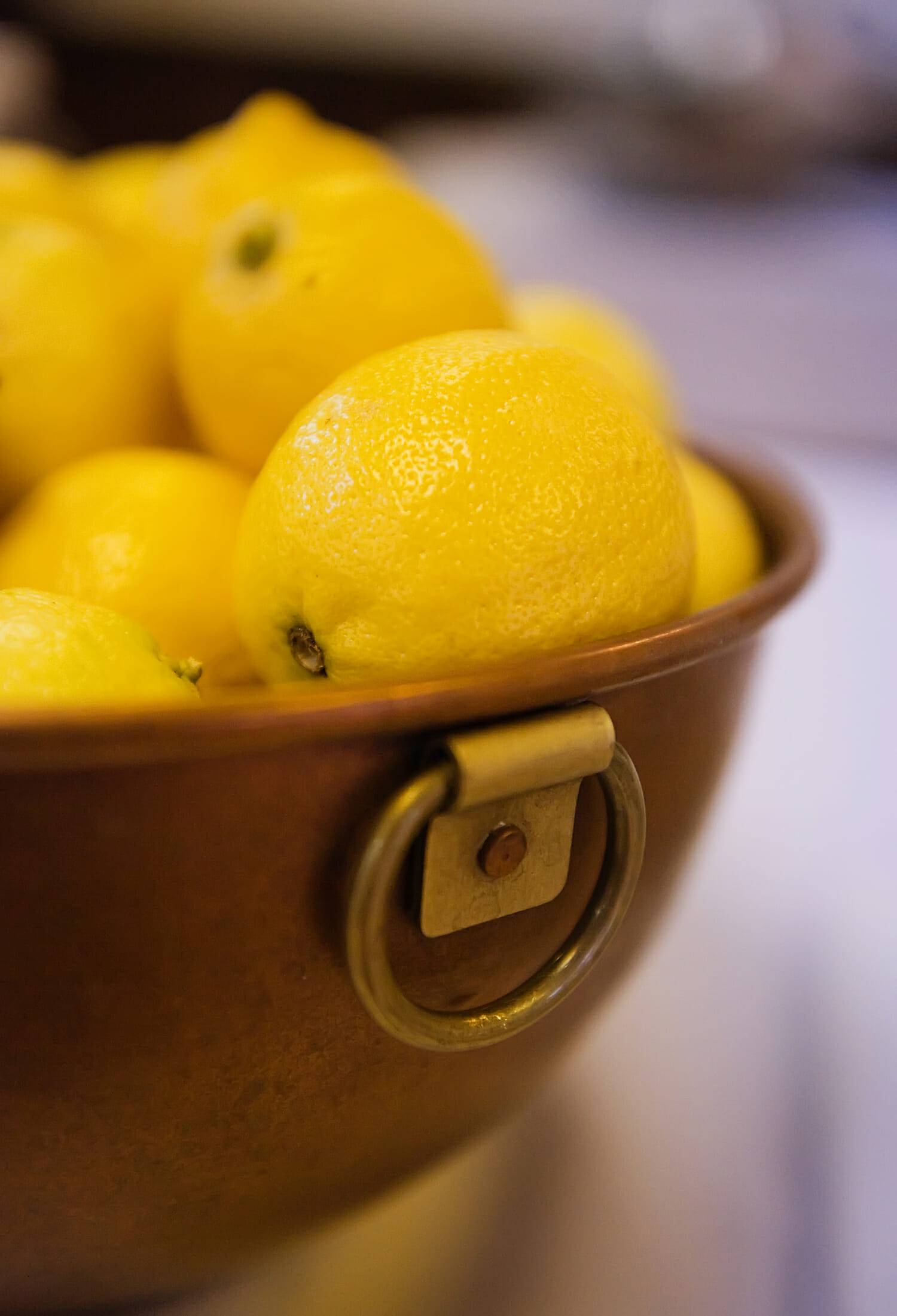 Copper bowl of lemons.