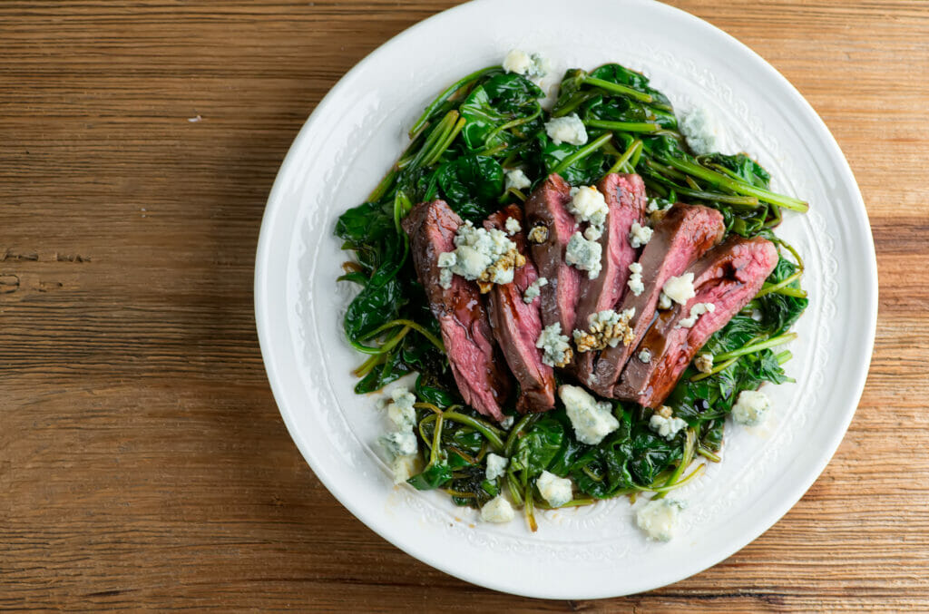 Balsamic Blue Cheese Steak With Spinach on a plate.