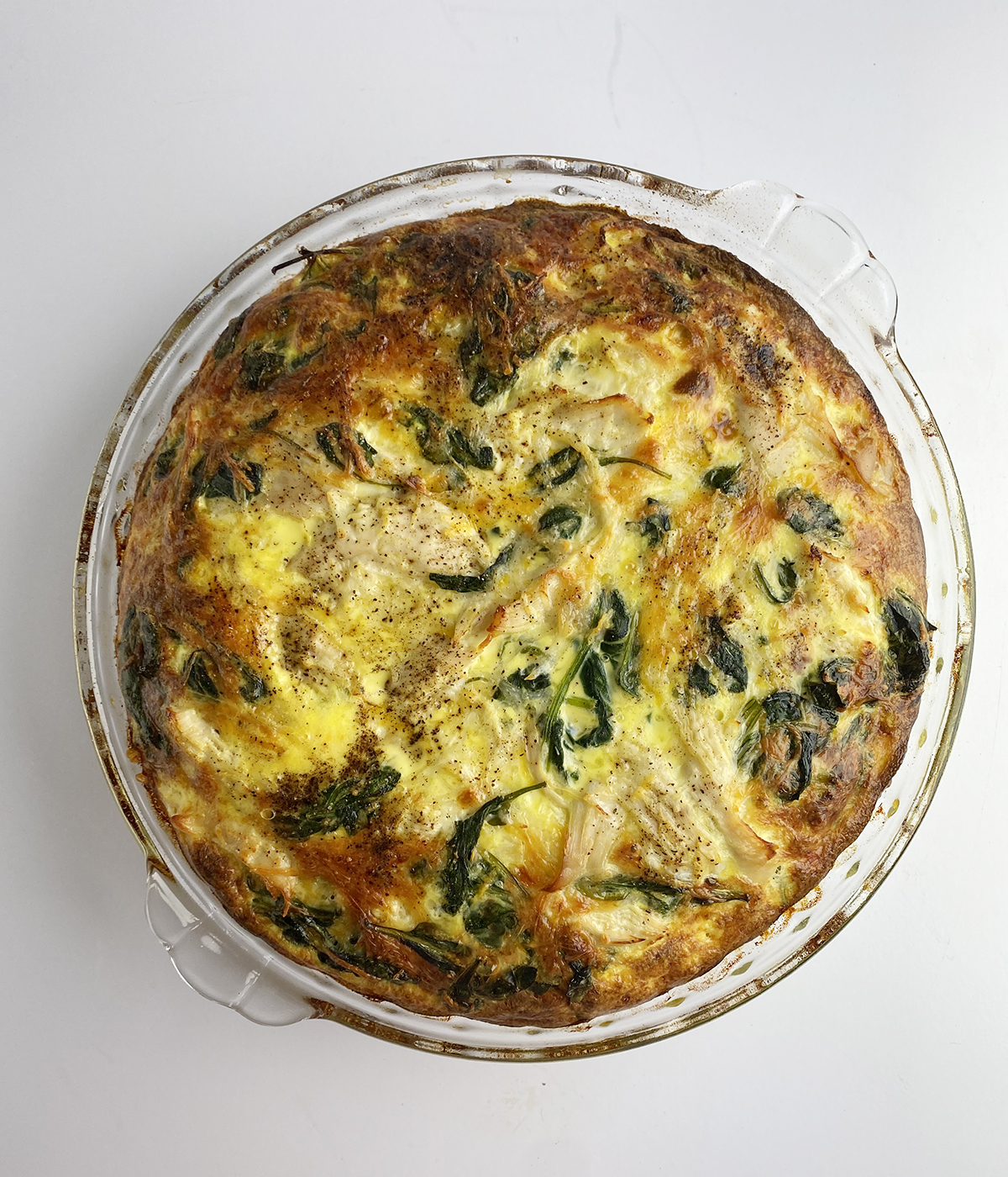 Baked chicken spinach frittata in a pie dish.