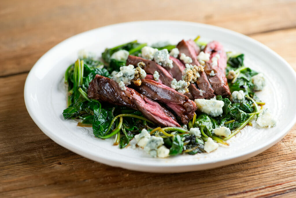 Balsamic Blue Cheese Steak With Spinach on a plate.