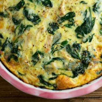 Cheesy chicken spinach oven frittata in a pie plate.