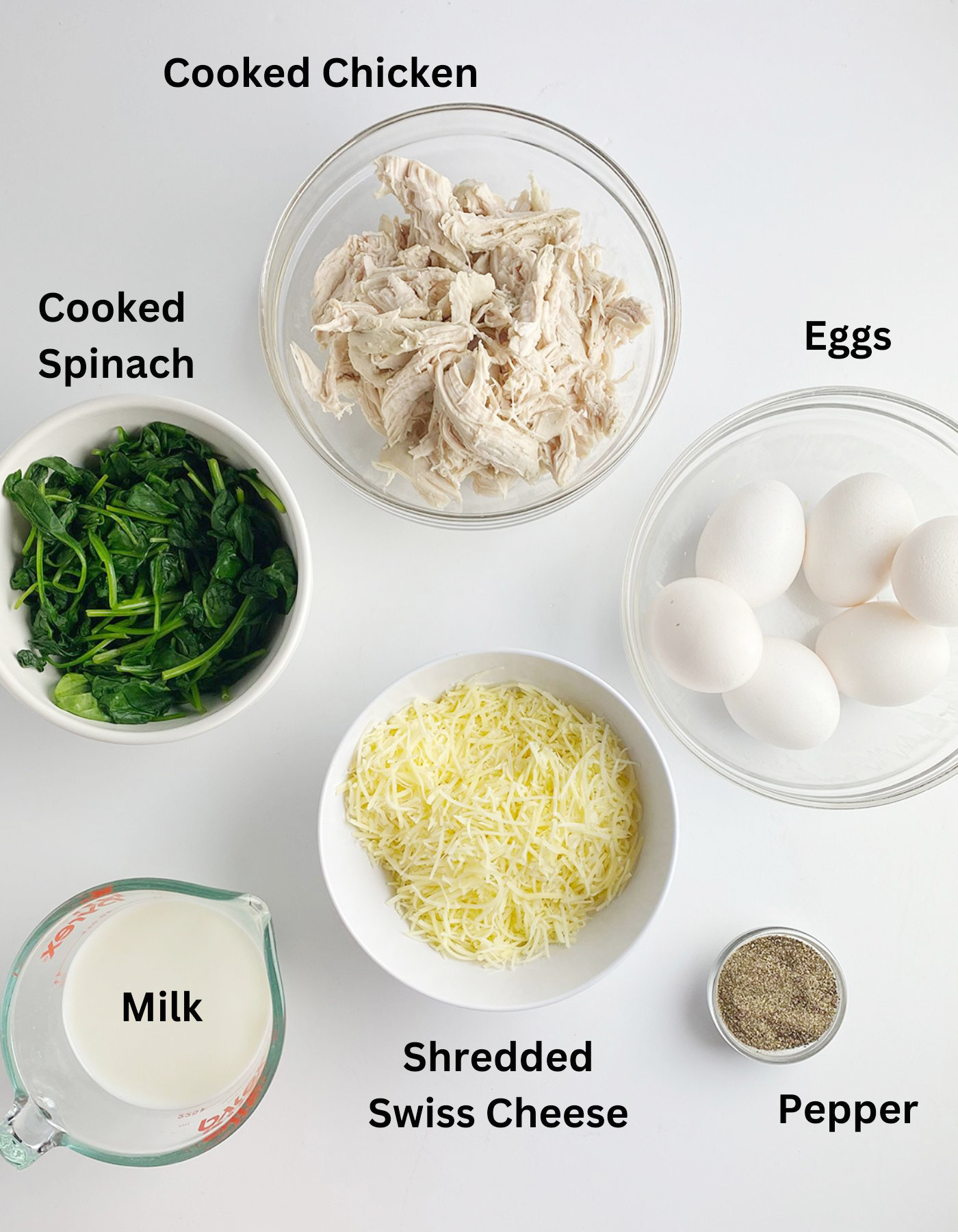 Ingredients for a chicken spinach frittata on a counter.