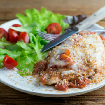 Easy One Pan Chicken Parmesan on a plate with a side salad.
