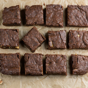Saucepan brownies with walnuts on a piece of parchment.