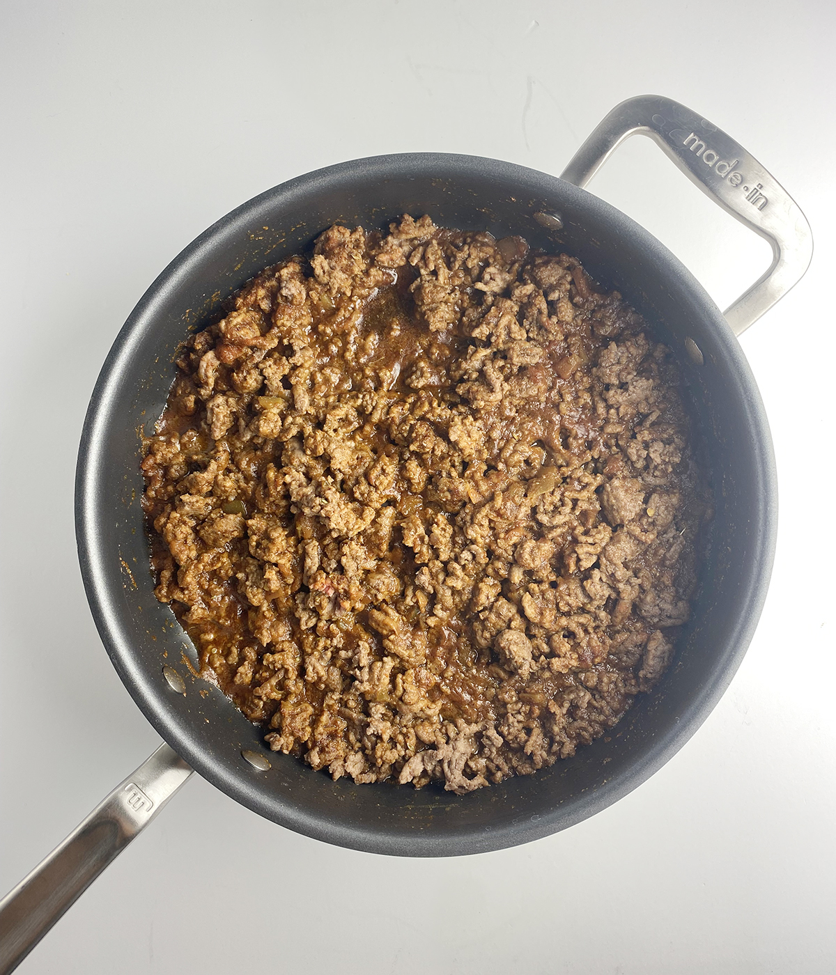 Cooked ground beef in a skillet.