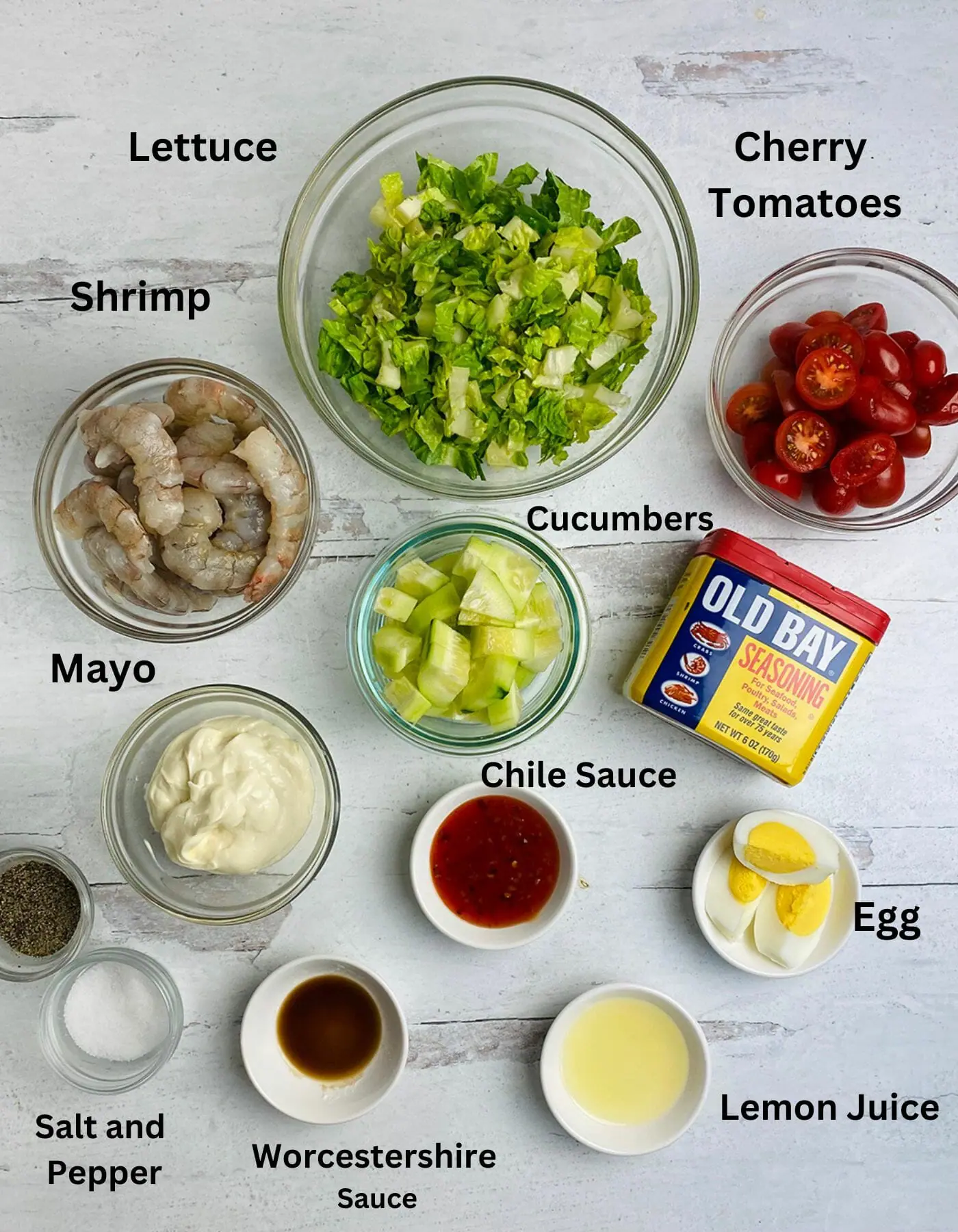 Shrimp louie salad ingredients on a wooden counter.