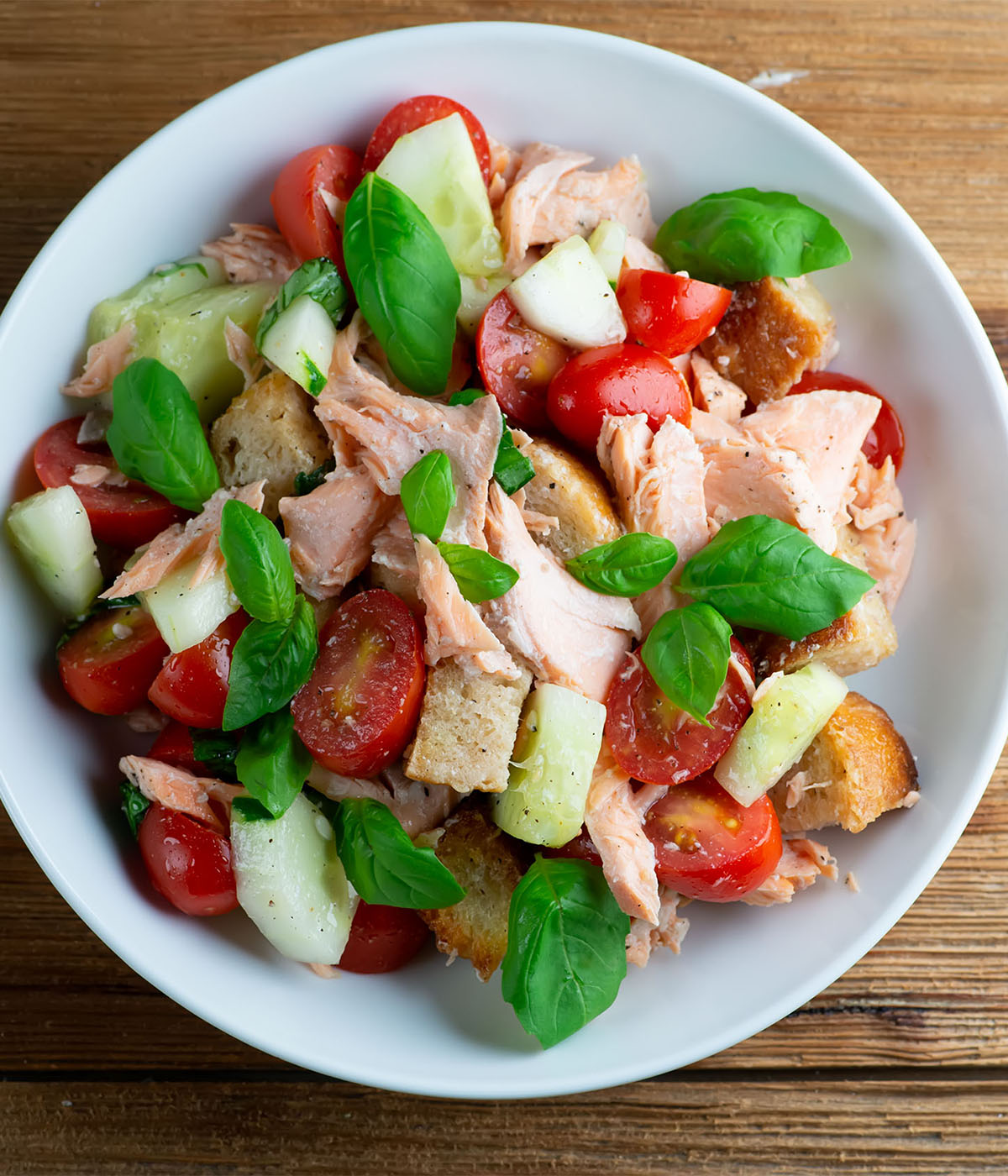 Salmon panzanella salad in a bowl.