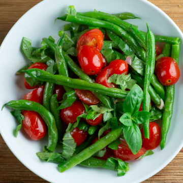 Cherry tomato green bean salad in a bowl.