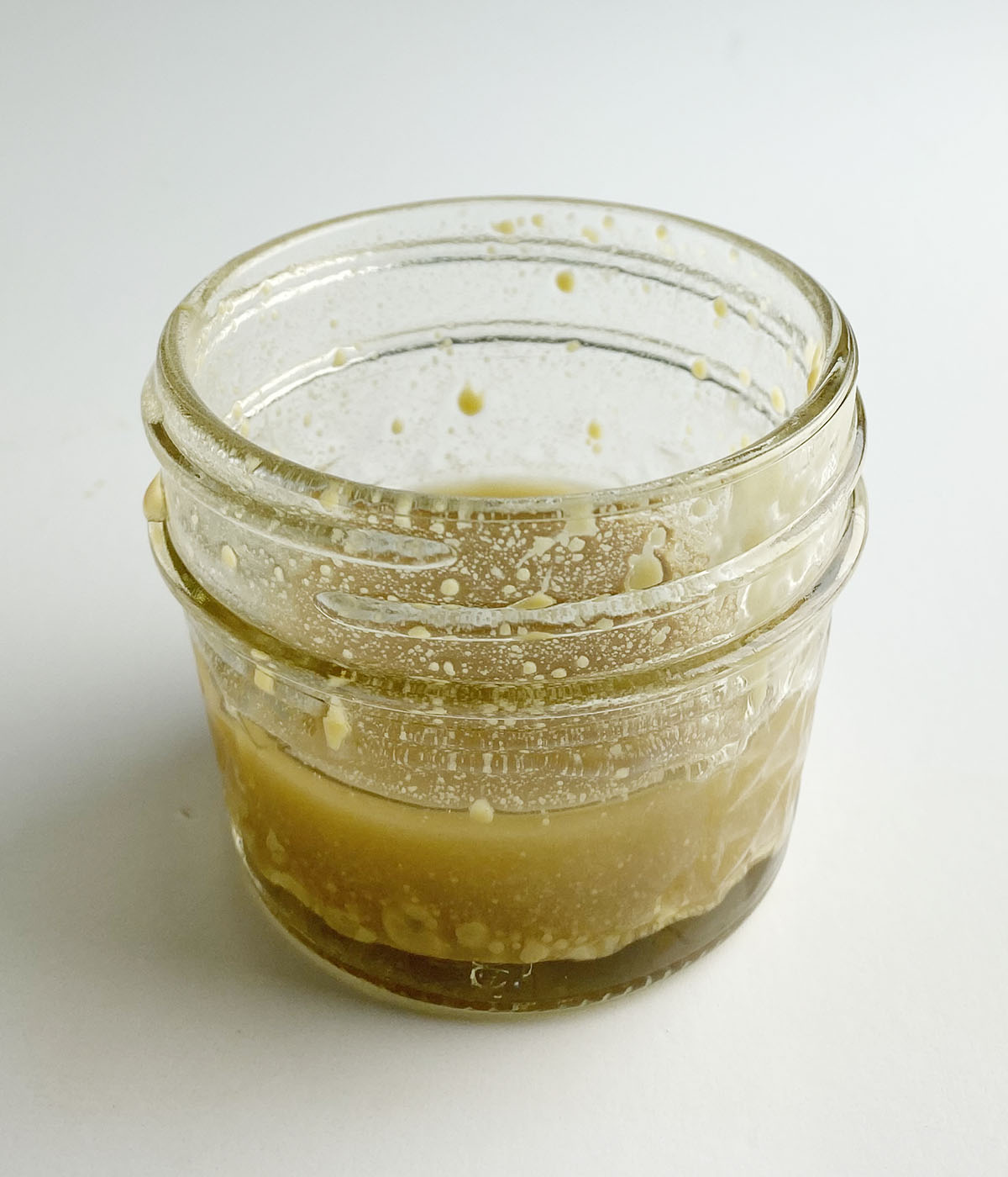 Mustard vinaigrette dressing in a jar.