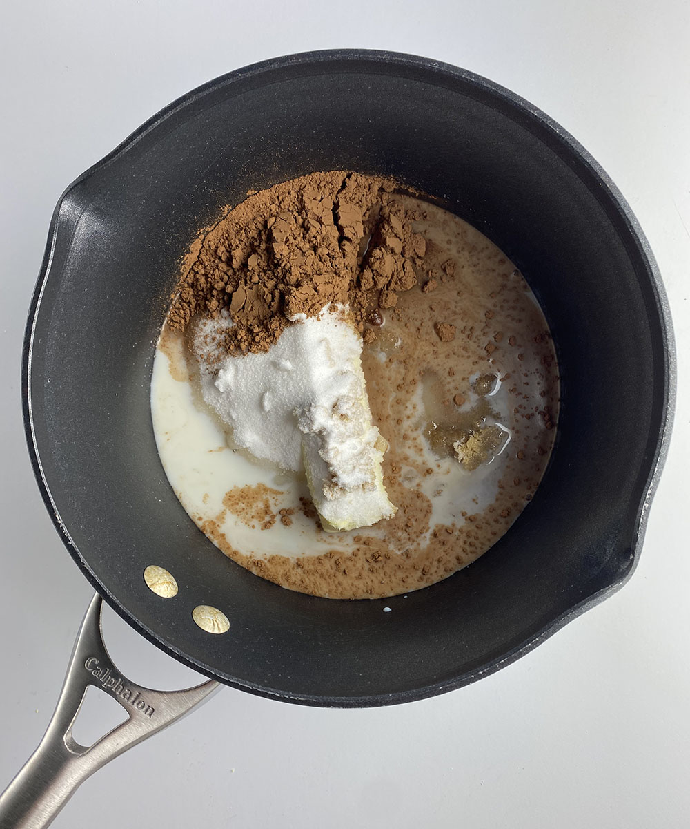 Butter sugar and cocoa in a pot.