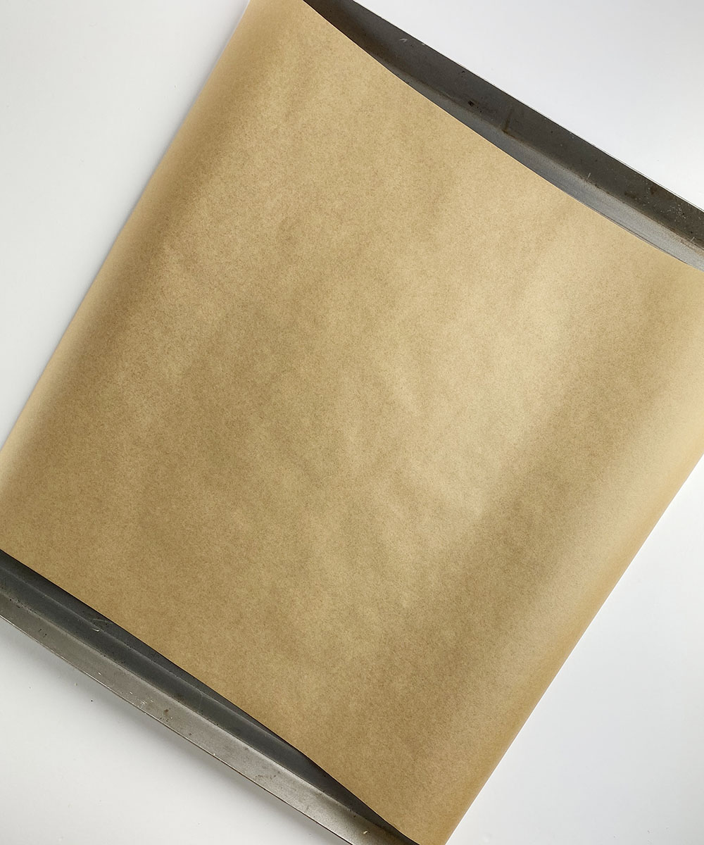 Cookie sheet lined with parchment.