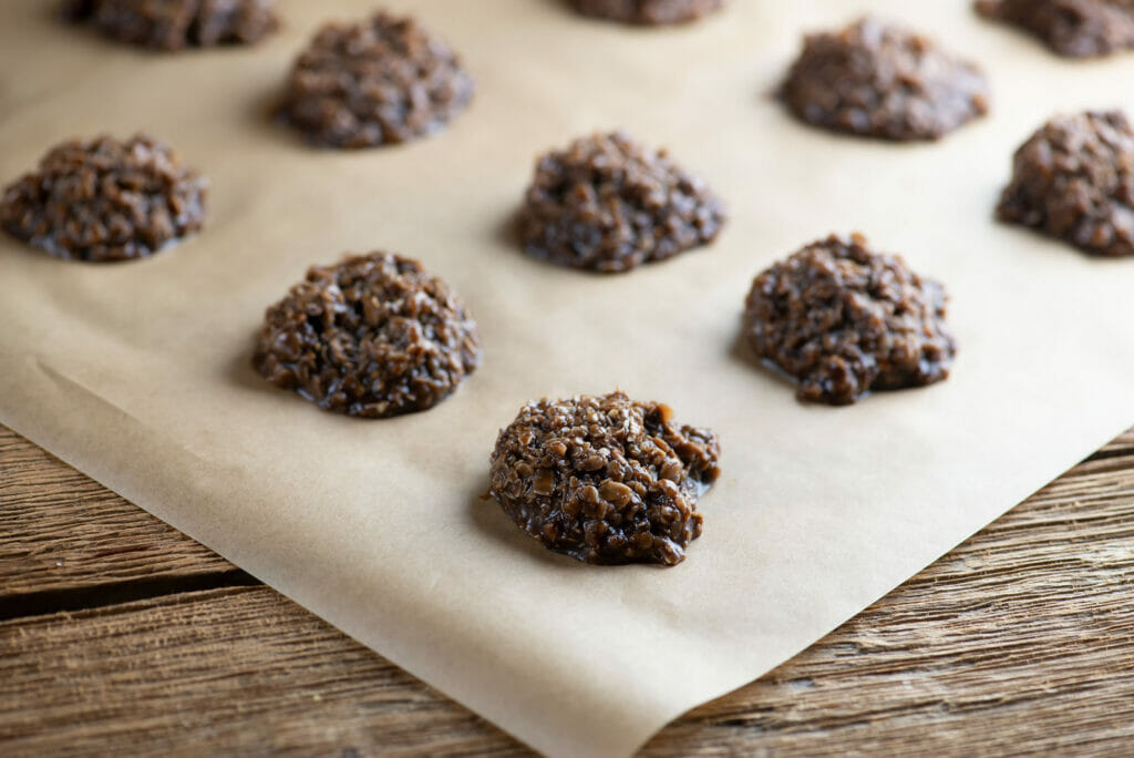 No bake chocolate haystack cookies on a sheet of parchment paper.