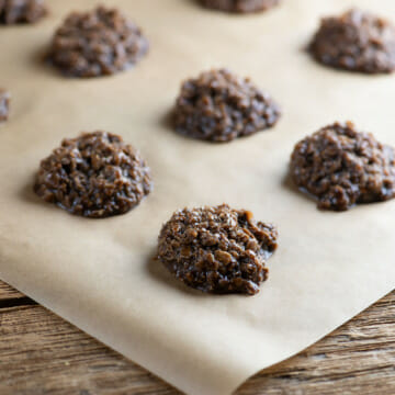 No bake chocolate haystack cookies on a sheet of parchment paper.