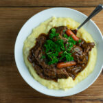 Maple Pot Roast in a bowl with polenta.