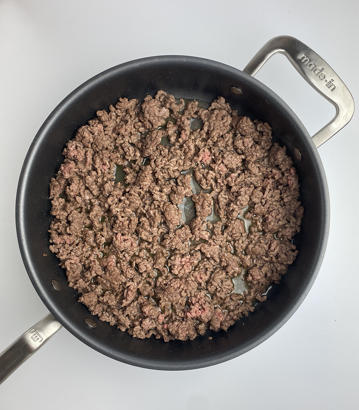 Cooked ground beef in a pan.