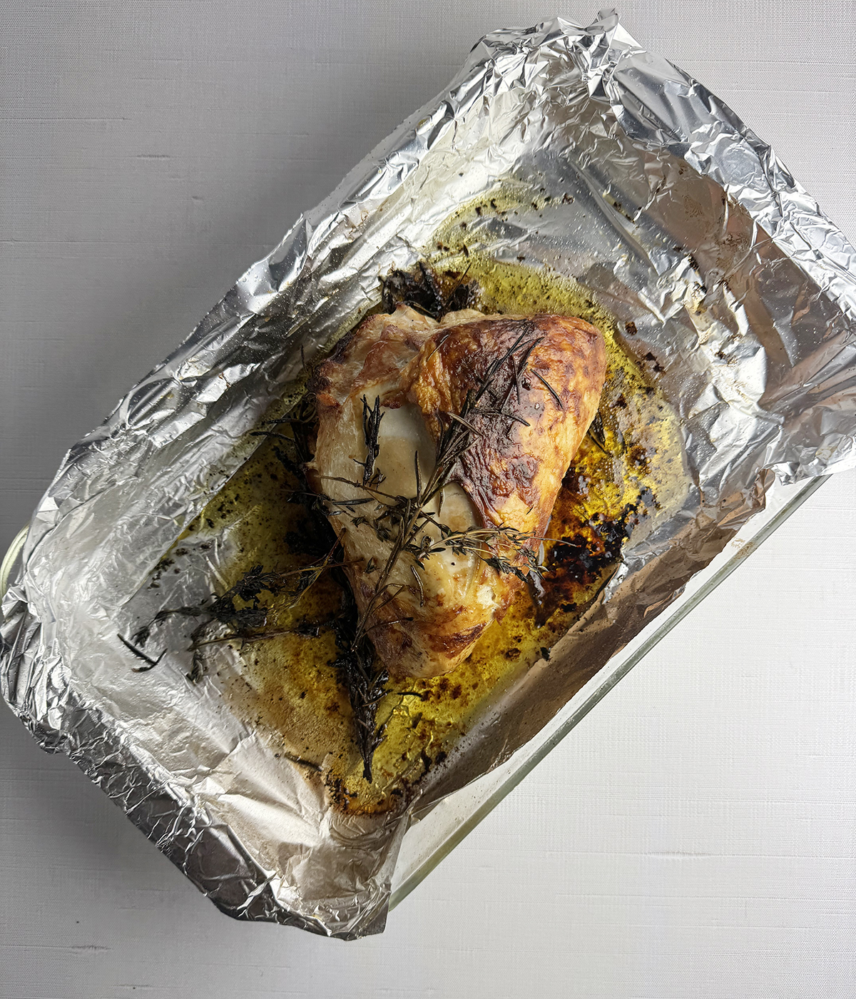 Roasted turkey breast in a roasting pan.