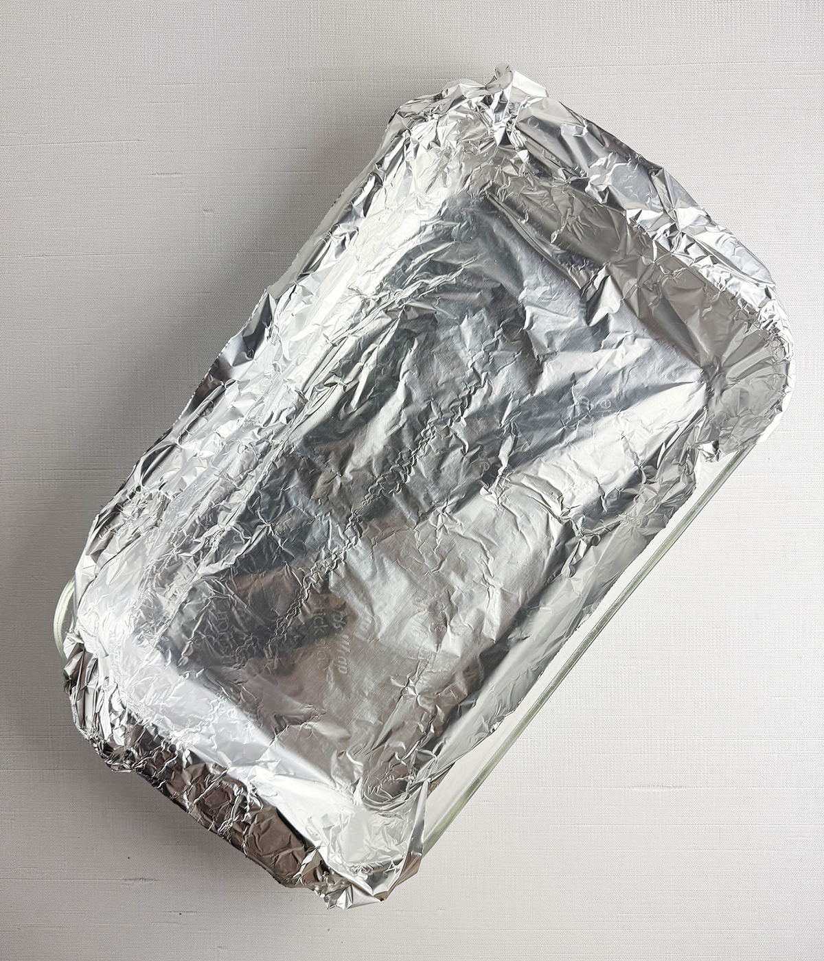 Roasting pan covered in foil.