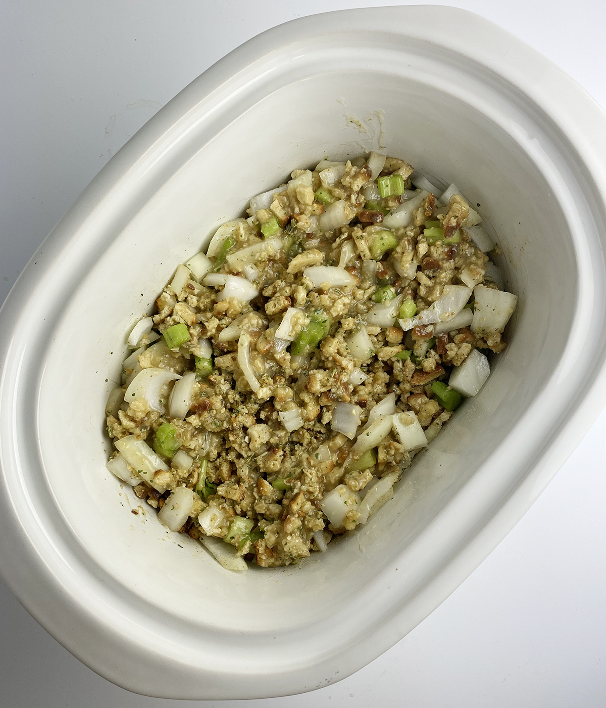 Stuffing mixture in slow cooker ready to be cooked.