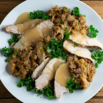 Easy slow cooker turkey with stuffing sliced and on a plate.