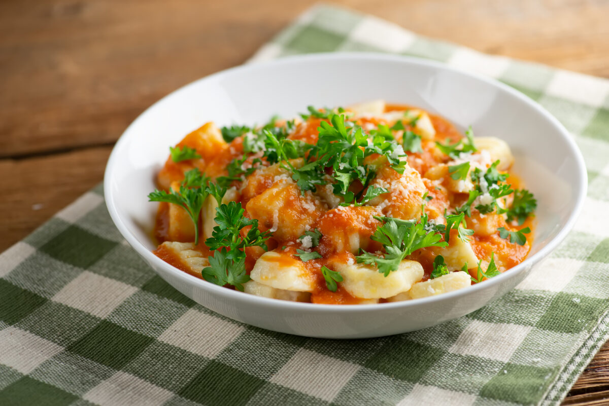 Mashed potato gnocchi in a bowl with tomato sauce.