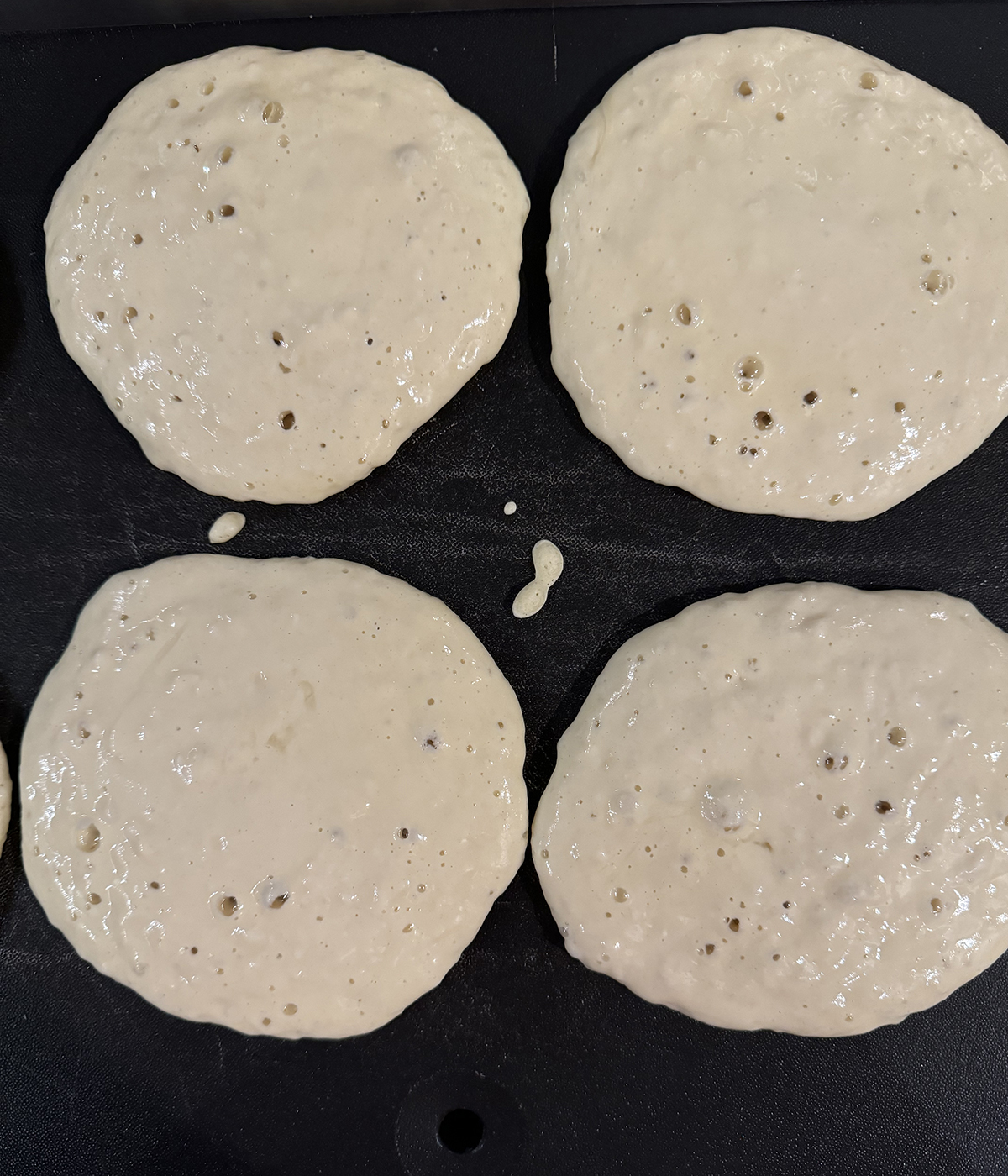 Pancake batter on a griddle.