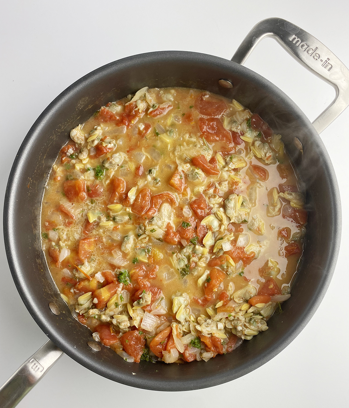 Clam marinara sauce in a skillet.