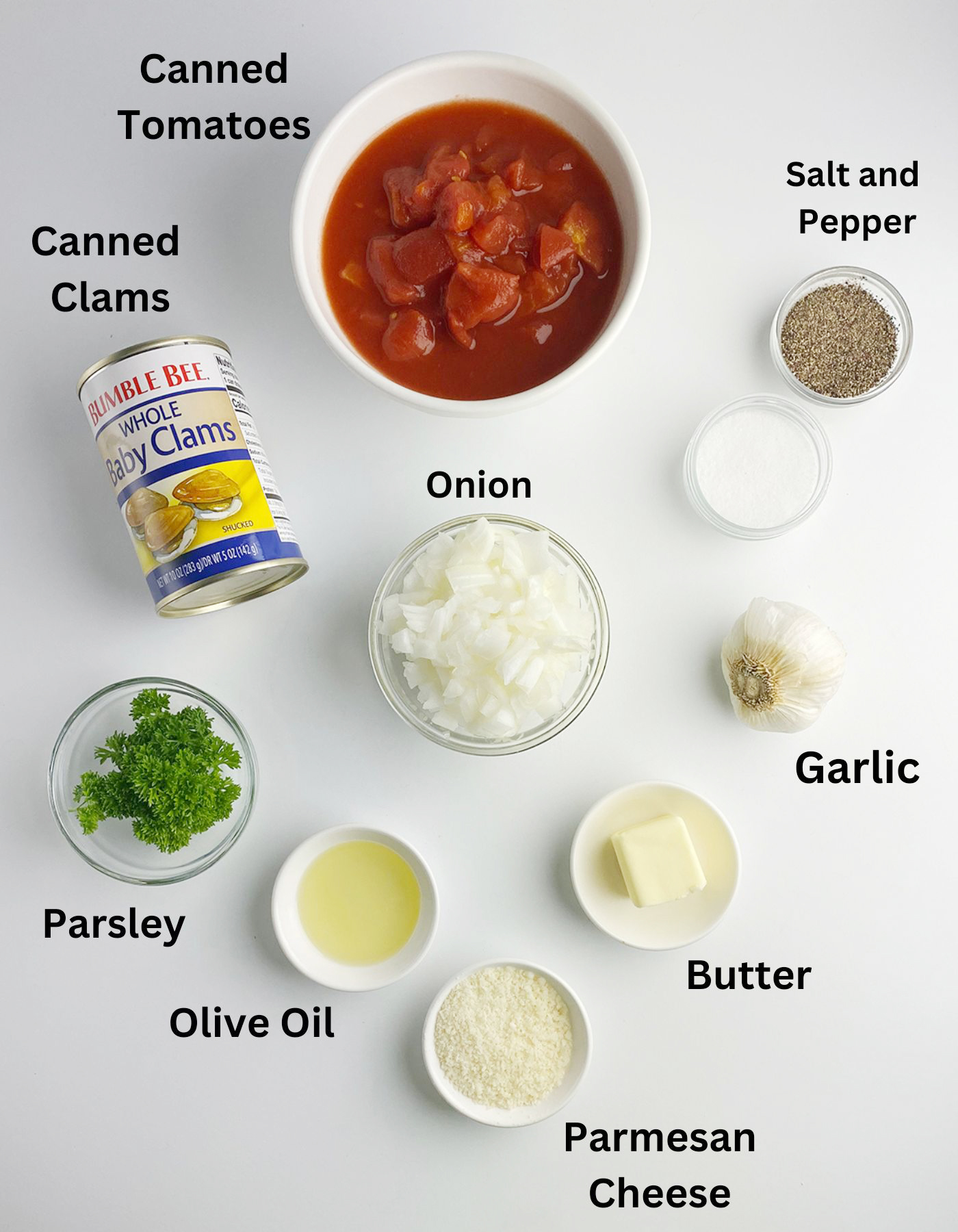 Ingredients for pasta with clam marinara sauce on a counter.