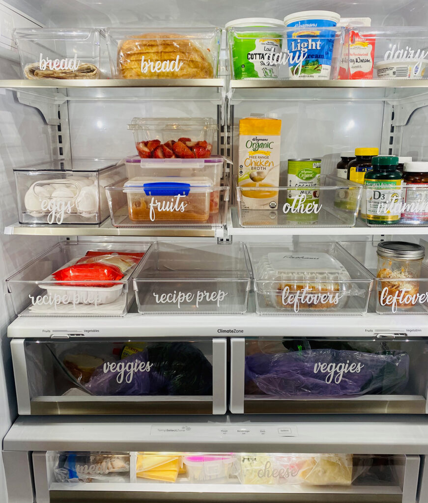 Organized fridge with labeled bins.