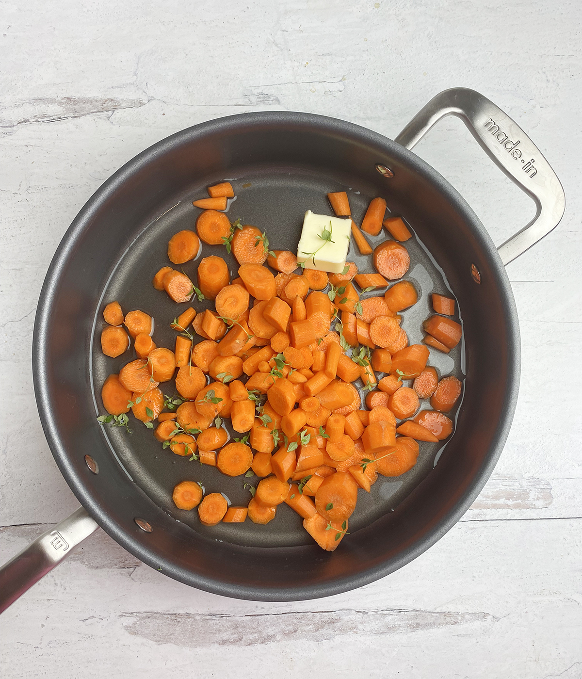 Carrots and butter in a skillet.