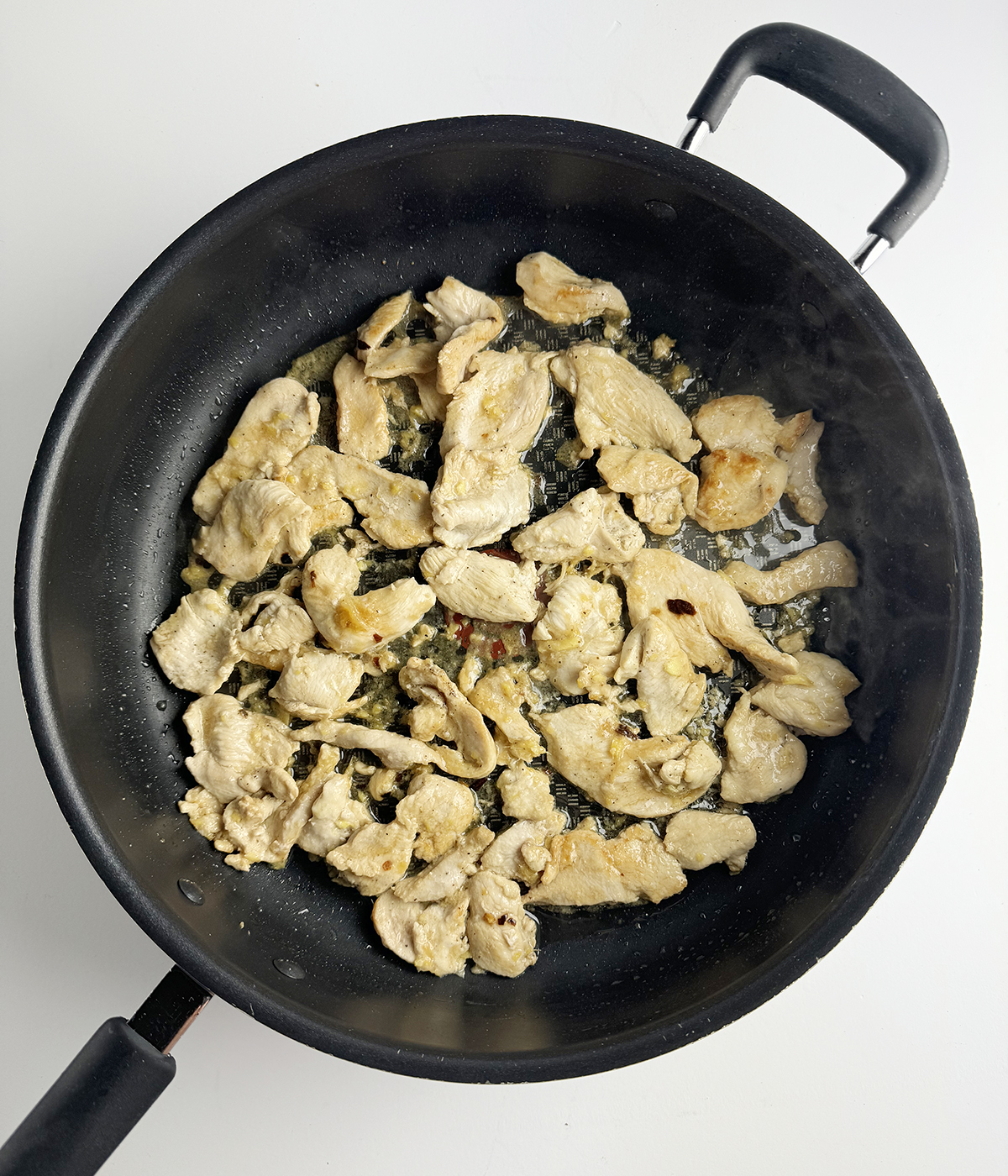 Sauteed chicken in a skillet.