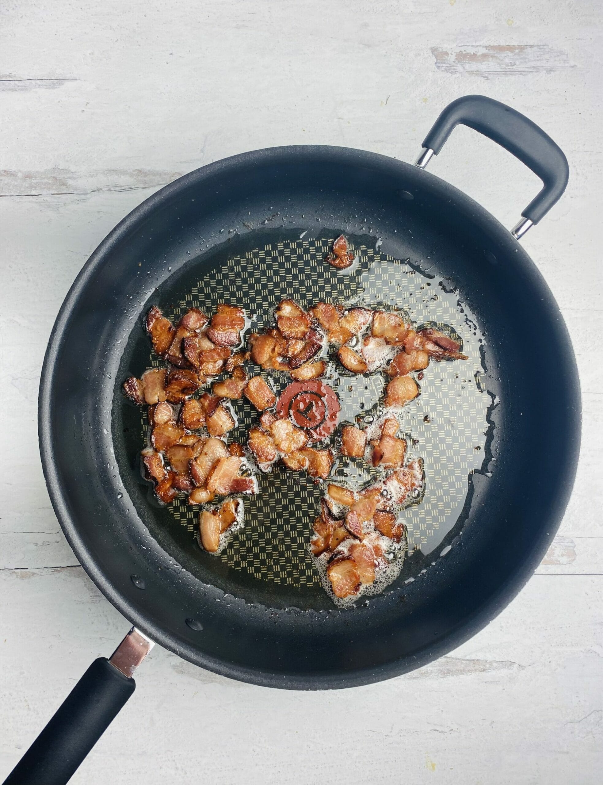 Bacon with drippings in a skillet.