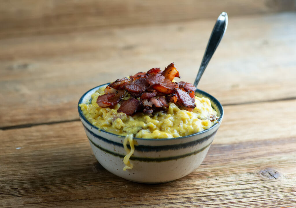 Breakfast ramen in a bowl with a spoon.