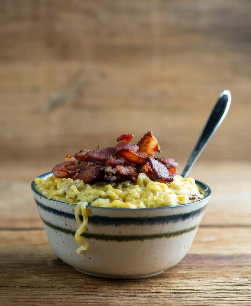 Breakfast ramen in a bowl with a spoon.