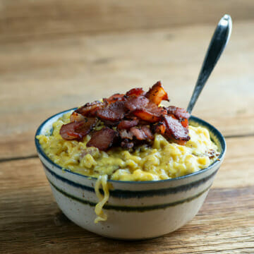 Breakfast ramen in a bowl with a spoon.