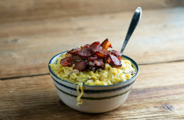 Breakfast ramen in a bowl with a spoon.