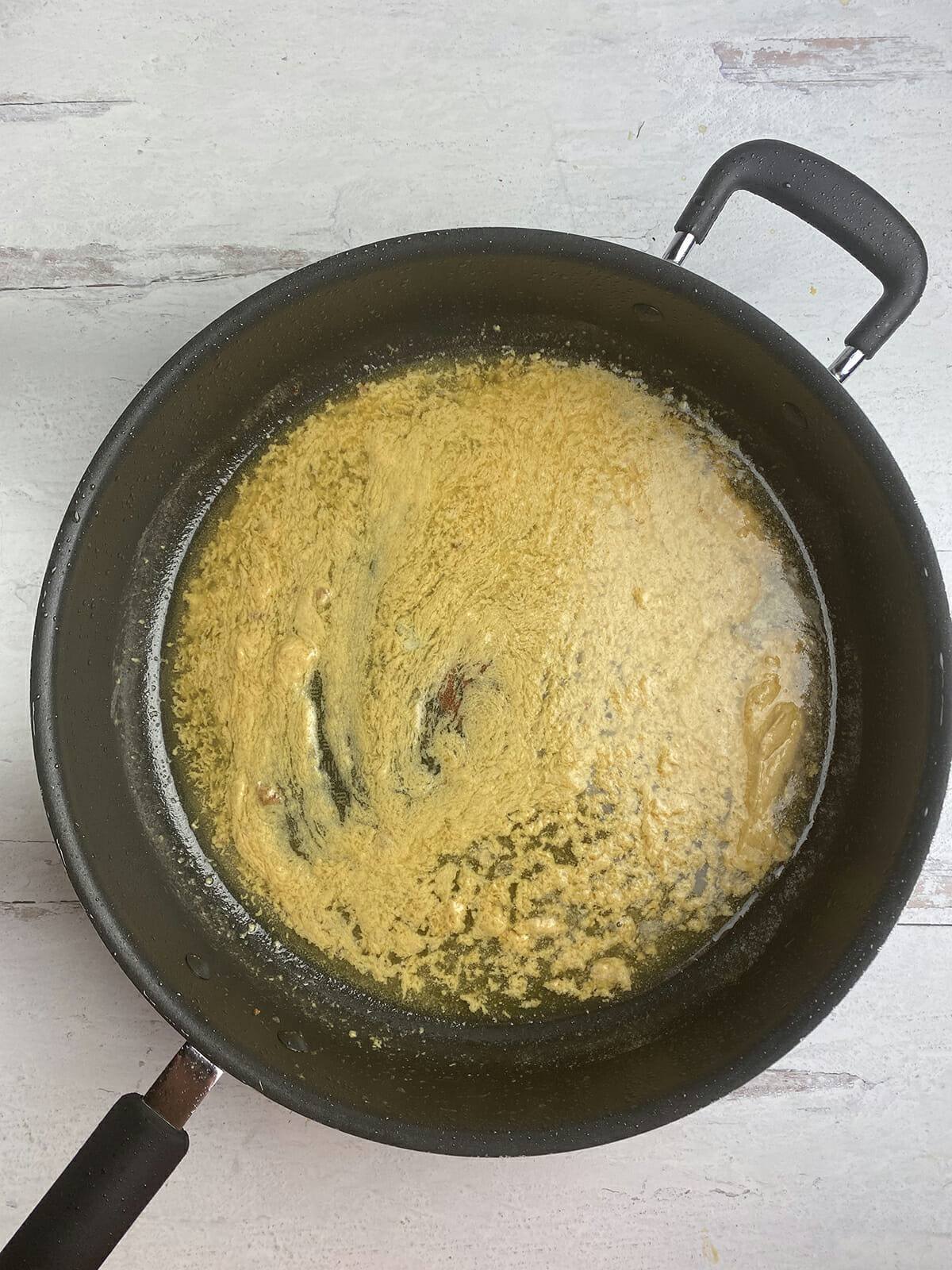 Pork medallion mustard butter sauce in a skillet.