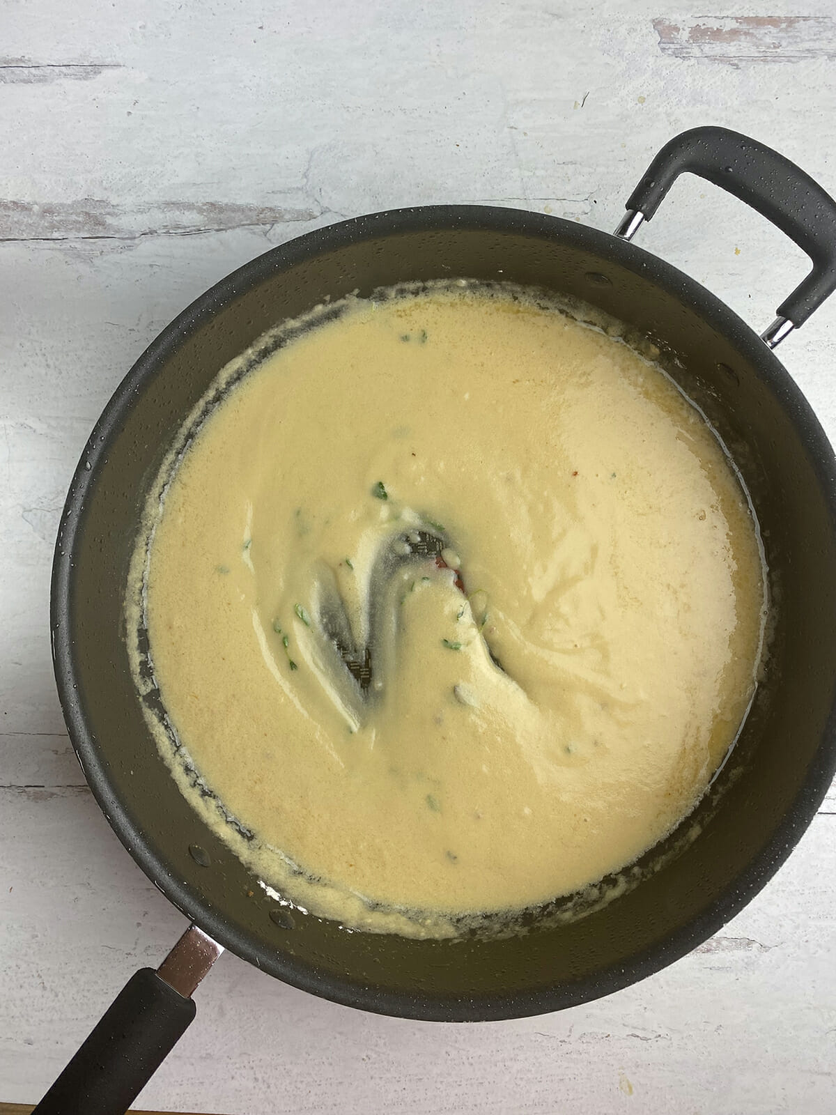 Pork medallion mustard sauce in a skillet.