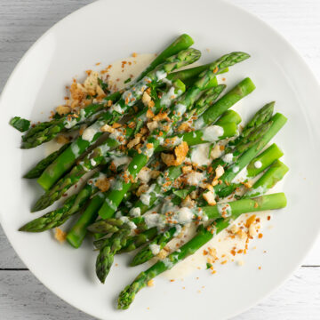 Asparagus with parmesan breadcrumbs on a plate.