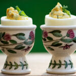 Tarragon deviled eggs in egg cups.