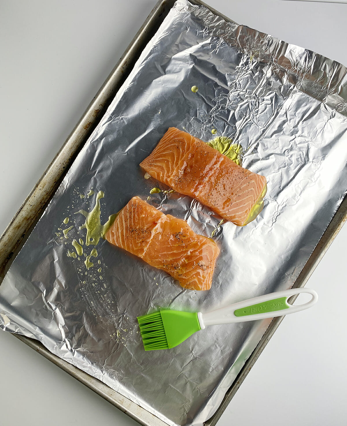 Basted salmon on baking sheet