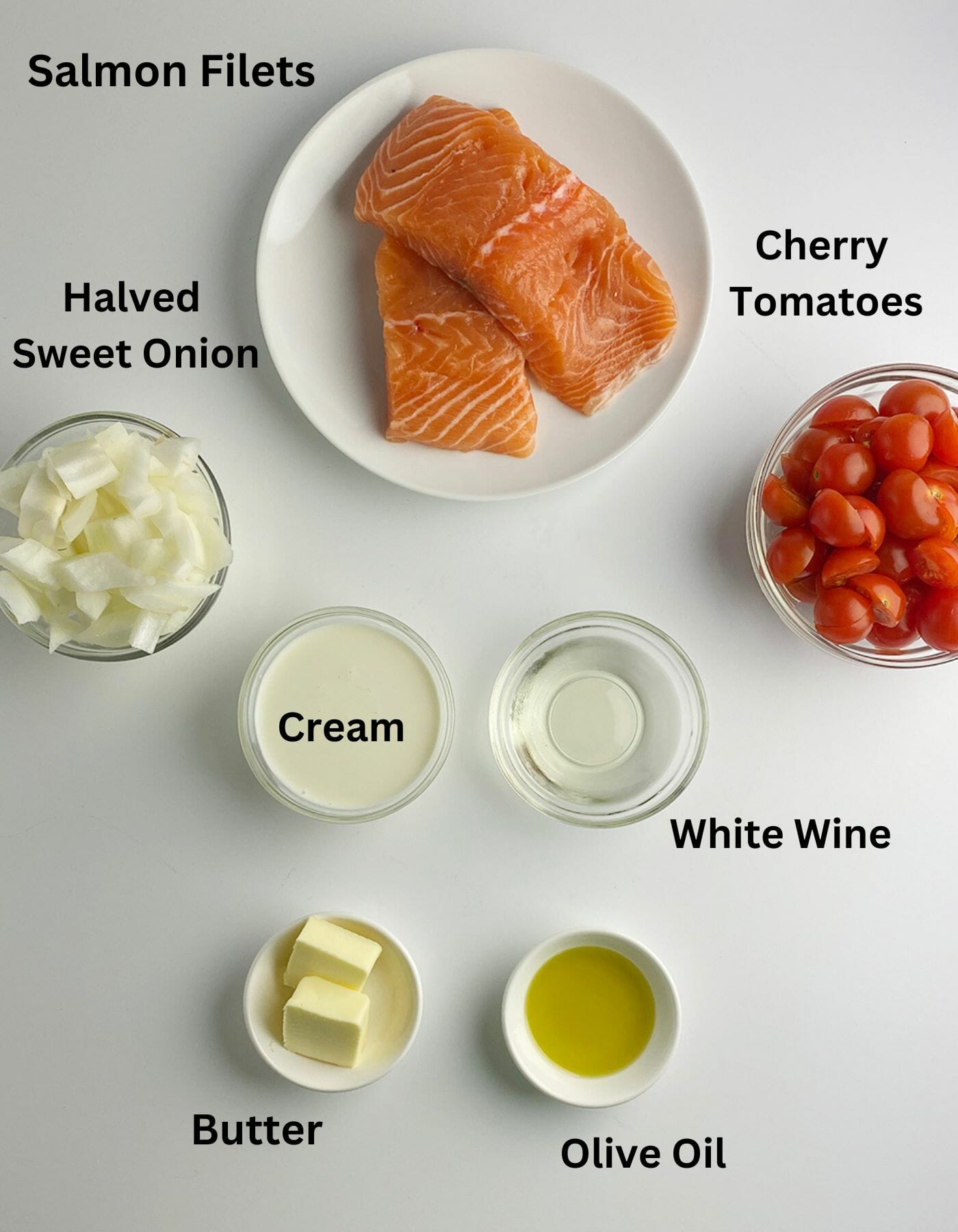 Ingredients for salmon with creamy tomato sauce on a counter.